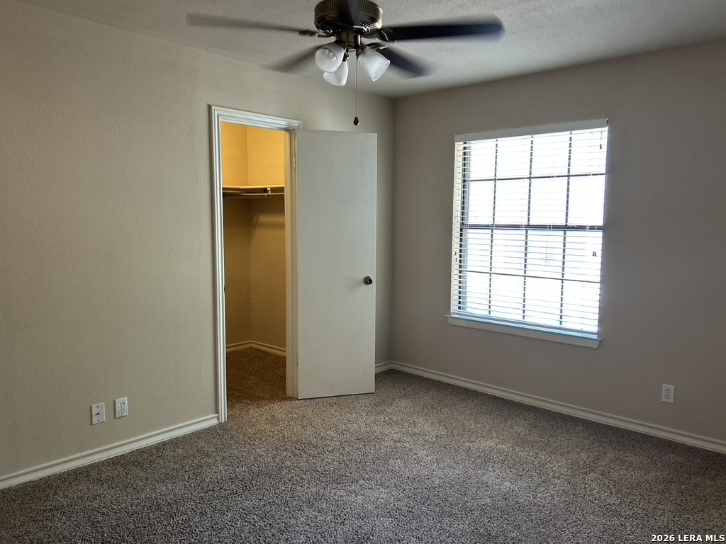 13018 Heimer Road, Unit 710 San Antonio, TX 78216 - Photo 15 of 27 an empty room with windows and ceiling fan