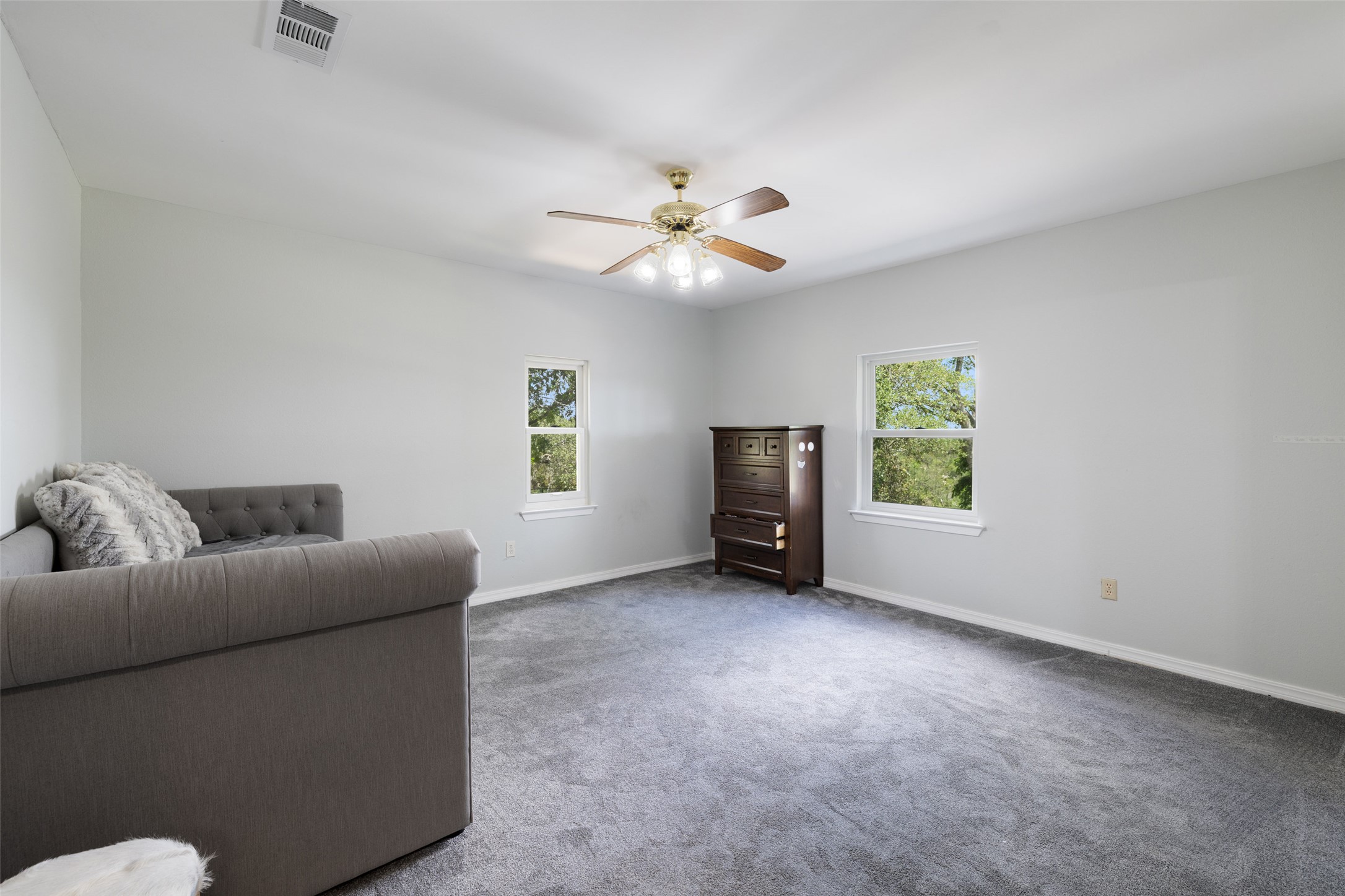 17700 North Rim Drive Leander, TX 78641 - Photo 24 of 38 Sitting room with plenty of natural light, a ceiling fan, carpet floors, and baseboards