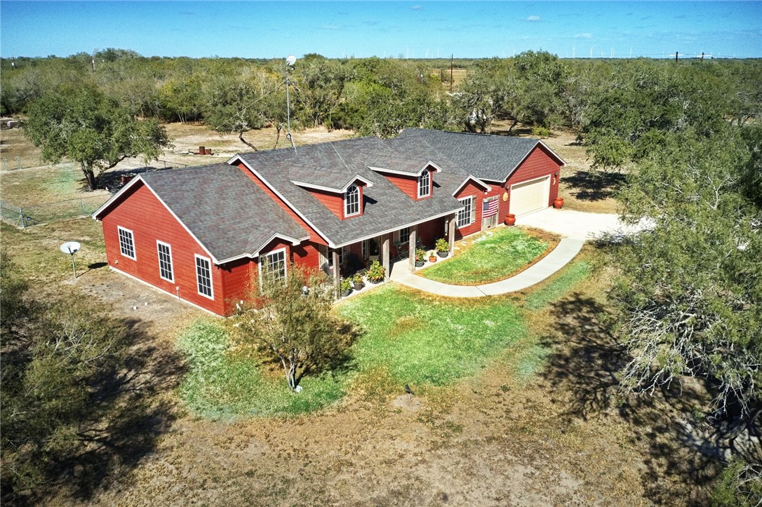 an aerial view of a house with pool