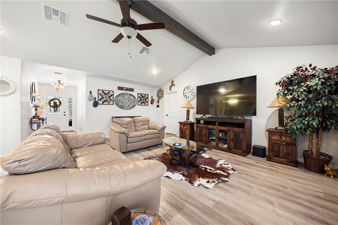 9227 Baker Road Sinton, TX 78387 - Photo 15 of 28 a living room with furniture and a flat screen tv