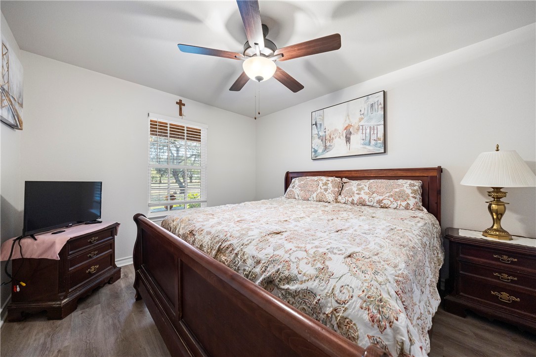 9227 Baker Road Sinton, TX 78387 - Photo 19 of 23 a bedroom with a bed and a flat screen tv