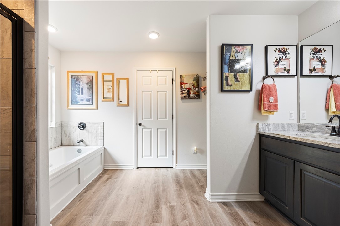 9227 Baker Road Sinton, TX 78387 - Photo 23 of 28 a bathroom with a tub a sink and a view of bathroom
