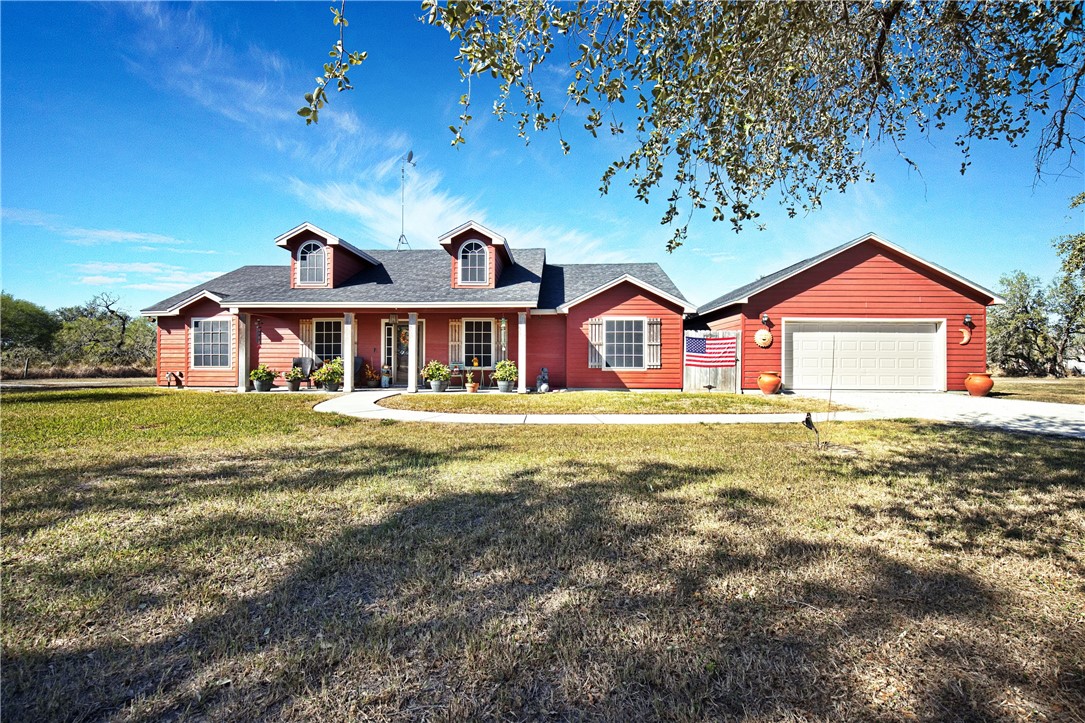 9227 Baker Road Sinton, TX 78387 - Photo 3 of 28 a front view of a house with a garden