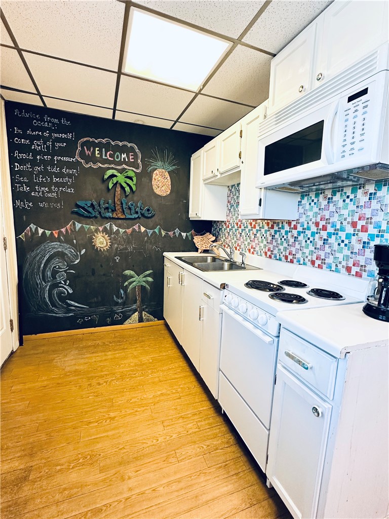 700 Island Retreat Road, Unit 14 Port Aransas, TX 78373 - Photo 16 of 23 a kitchen with stainless steel appliances a stove and a microwave
