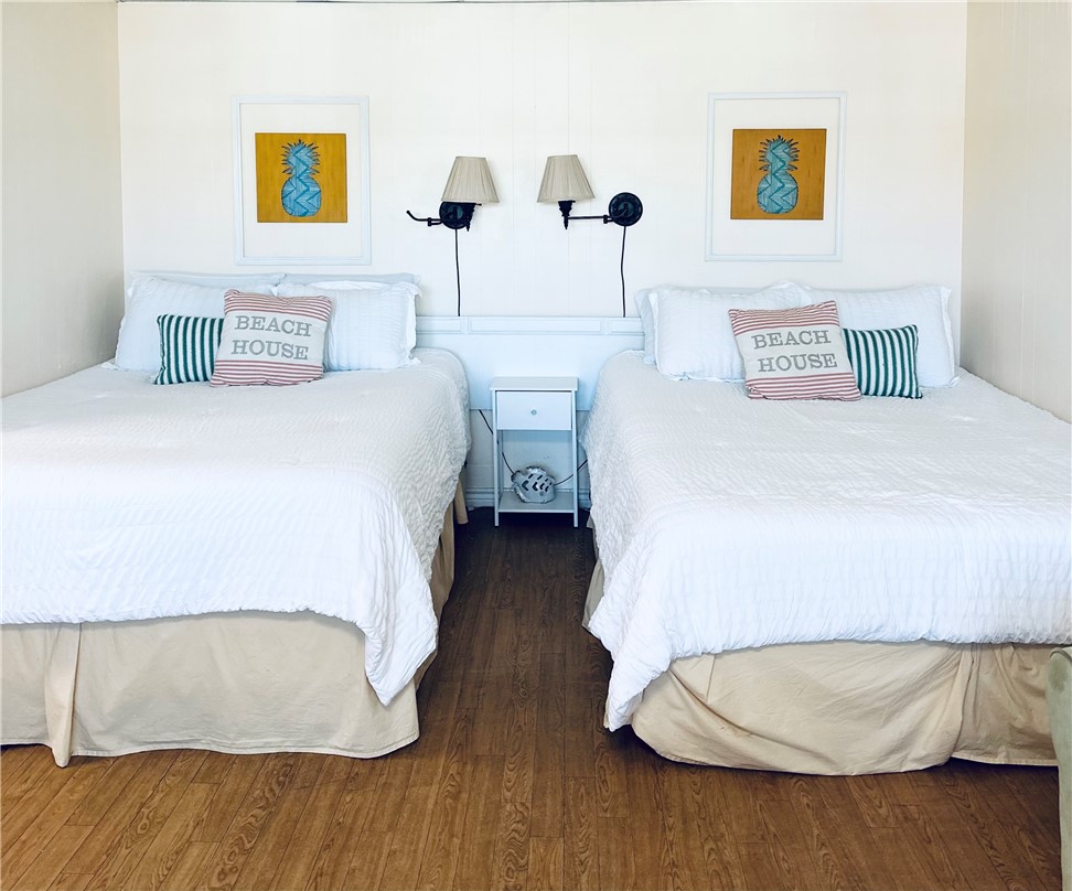 700 Island Retreat Road, Unit 14 Port Aransas, TX 78373 - Photo 17 of 23 a bedroom with a bed and a night stand