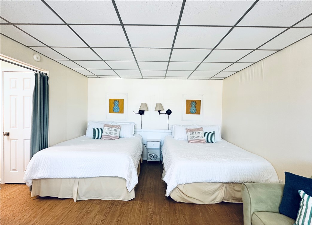 700 Island Retreat Road, Unit 14 Port Aransas, TX 78373 - Photo 18 of 23 a bedroom with two beds and a couch