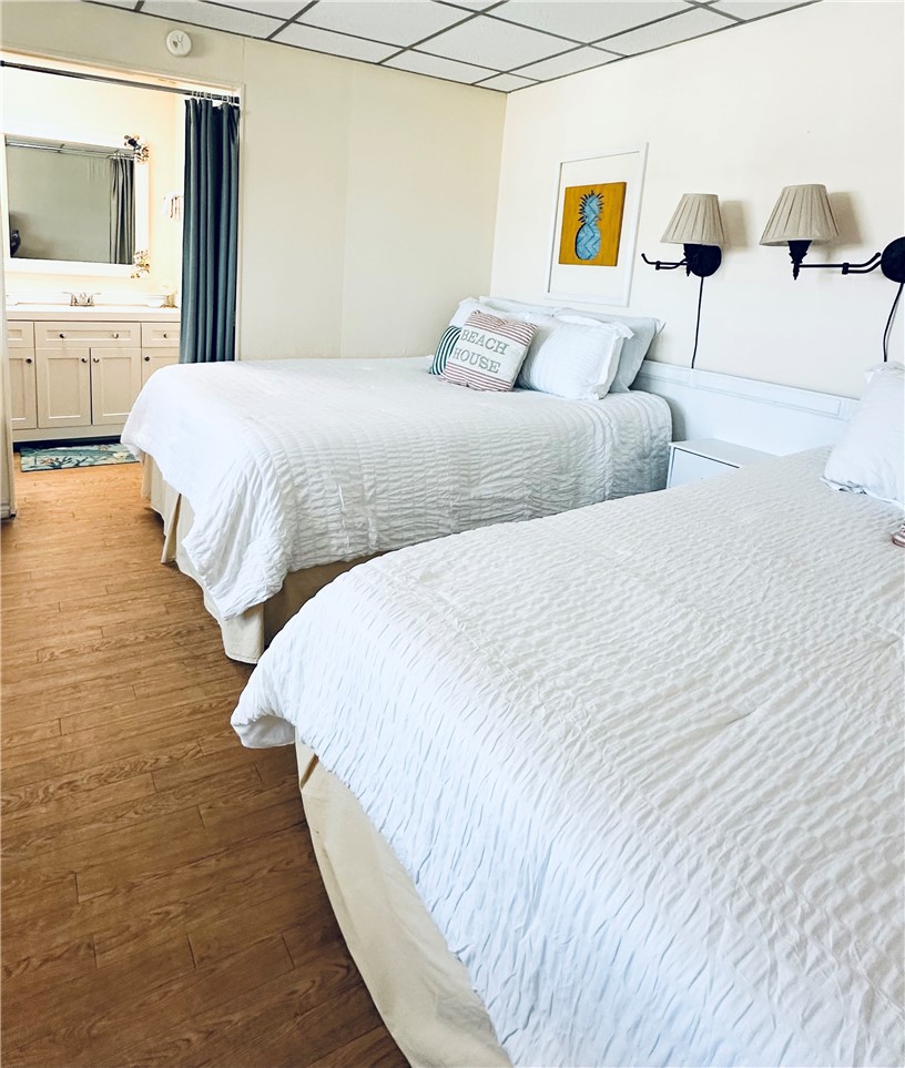 700 Island Retreat Road, Unit 14 Port Aransas, TX 78373 - Photo 19 of 23 a bedroom with a bed and a flat screen tv