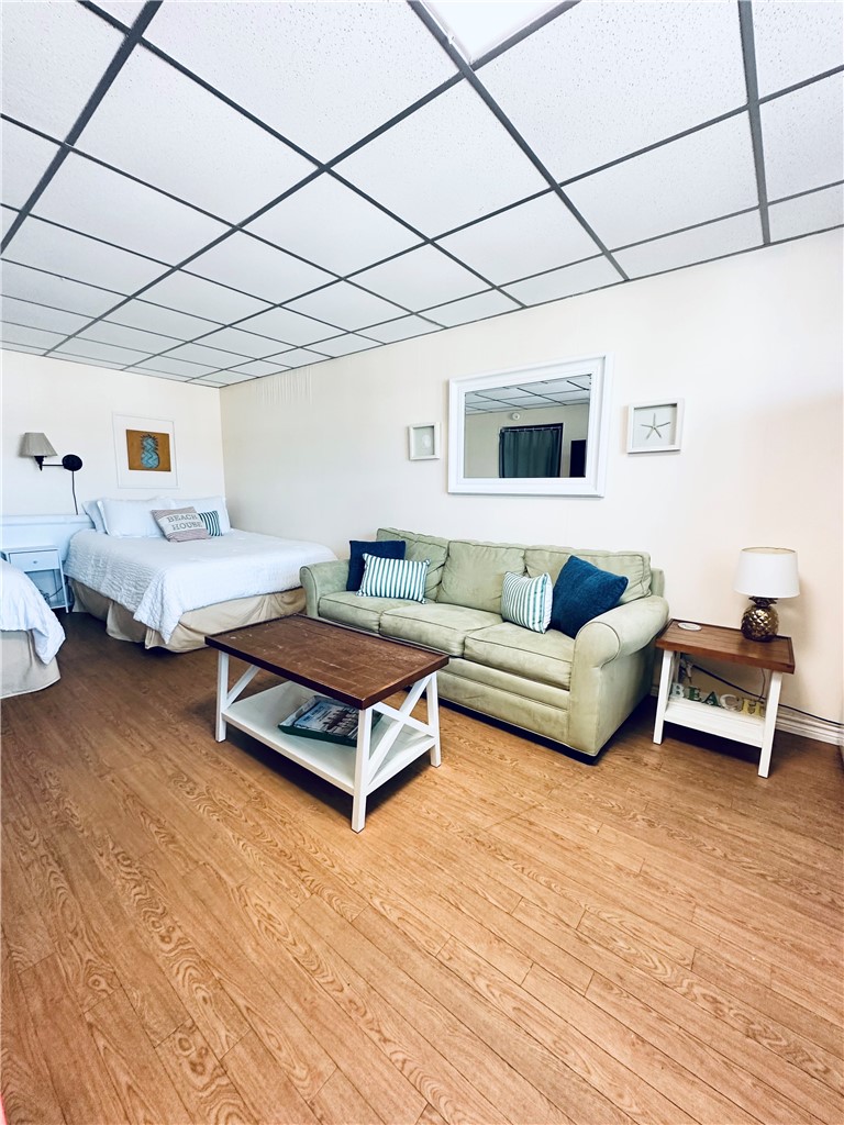 700 Island Retreat Road, Unit 14 Port Aransas, TX 78373 - Photo 21 of 23 a bedroom with furniture and a wooden floor