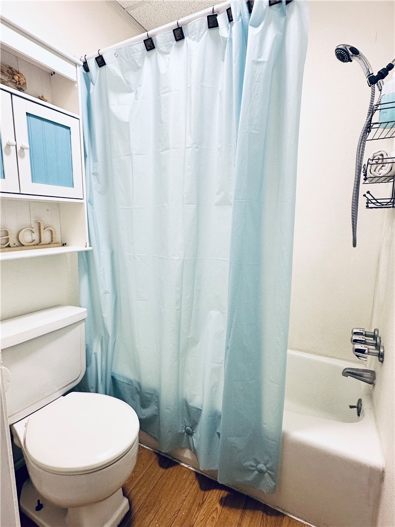 700 Island Retreat Road, Unit 14 Port Aransas, TX 78373 - Photo 22 of 23 a bathroom with a toilet and a shower curtain