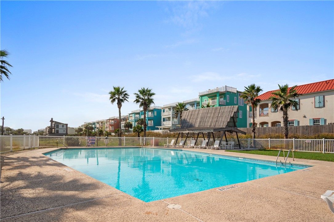 700 Island Retreat Road, Unit 14 Port Aransas, TX 78373 - Photo 6 of 23 a view of a swimming pool with a lake from a terrace