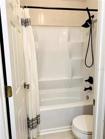 a bathroom with a shower and a toilet