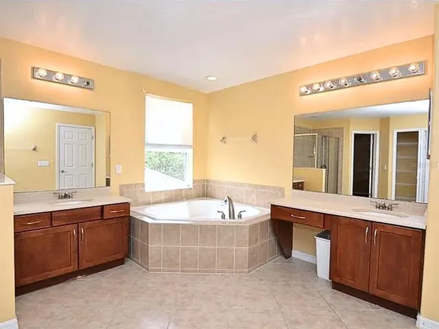 a spacious bathroom with a large tub shower and sink