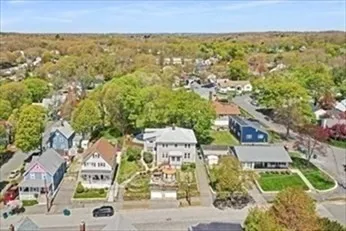 a view of a chair and table in backyard of the house