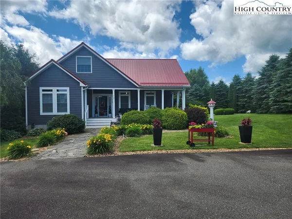 a view of a house with a yard and plants