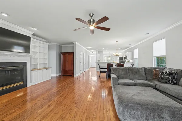 a living room with furniture fireplace and flat screen tv