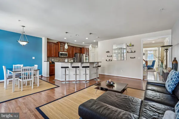 a living room with furniture and kitchen view