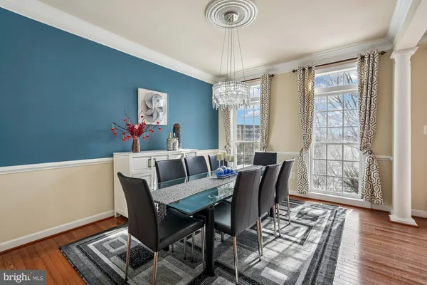 a view of a dining room with furniture wooden floor and chandelier