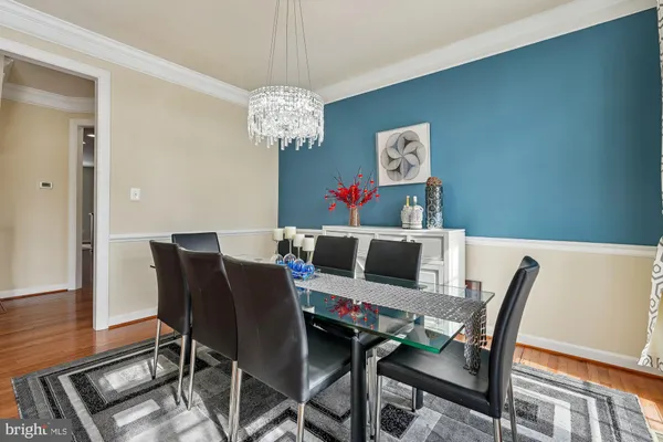 a view of a dining room with furniture wooden floor and a chandelier