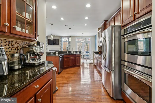 a kitchen with stainless steel appliances a stove a sink and a microwave