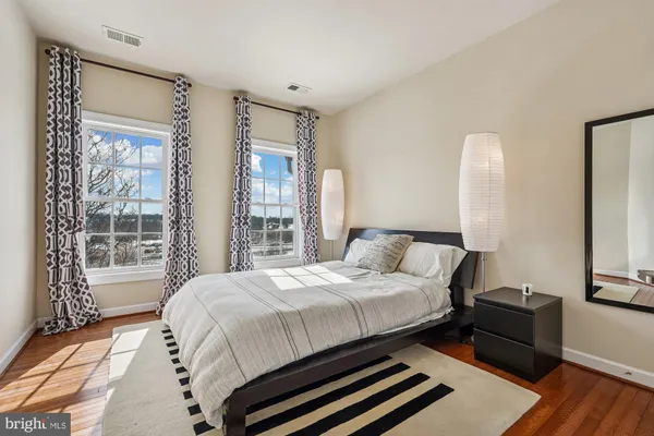a bedroom with a bed and a mirror