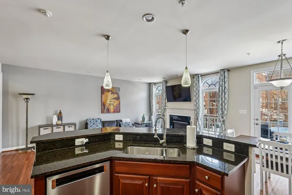 a kitchen with granite countertop a sink and stove