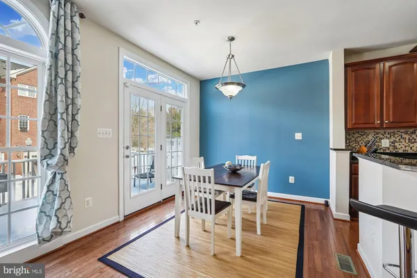a view of a dining room with furniture wooden floor and chandelier