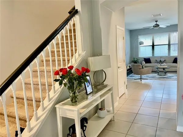 a living room with furniture and flowers