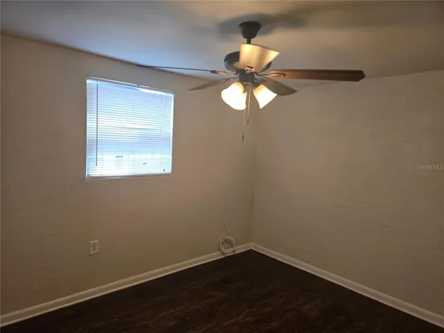 a view of a small space with wooden floor and windows