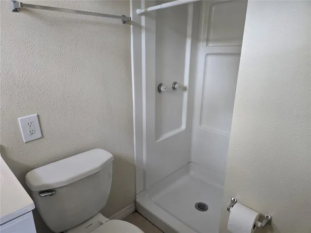 a bathroom with a shower and toilet