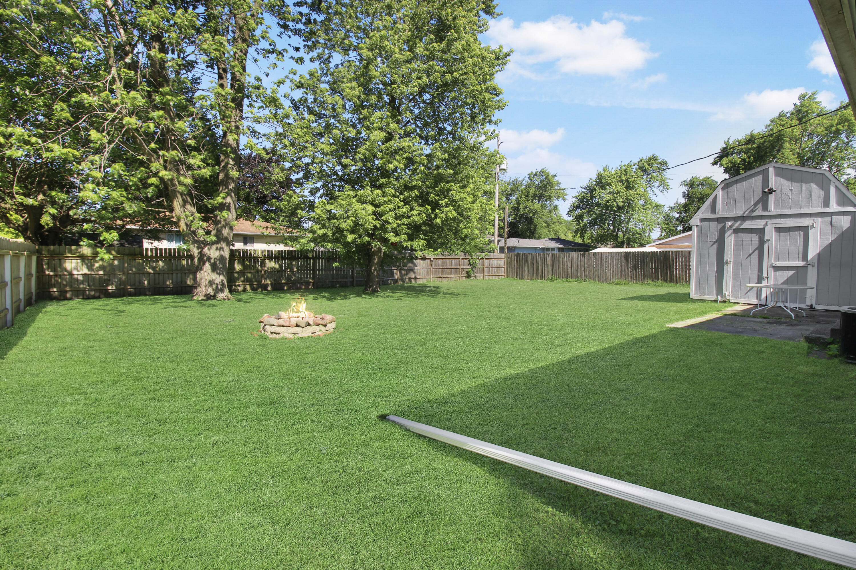 7714 Wallace Street Merrillville, IN 46410 - Photo 4 of 14 a view of a backyard with a garden