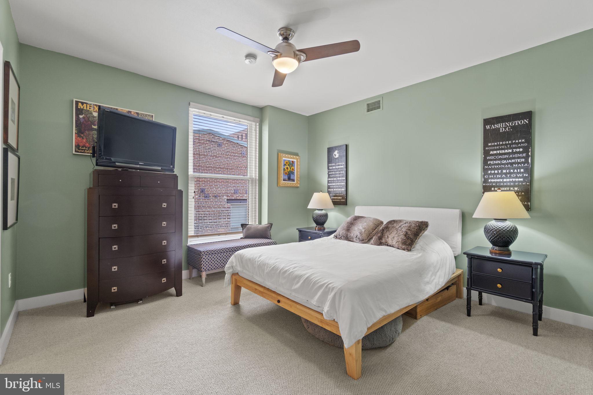 675 E Street Northwest, Unit 500 Washington, DC 20004 - Photo 15 of 52 a bedroom with a bed and a chandelier