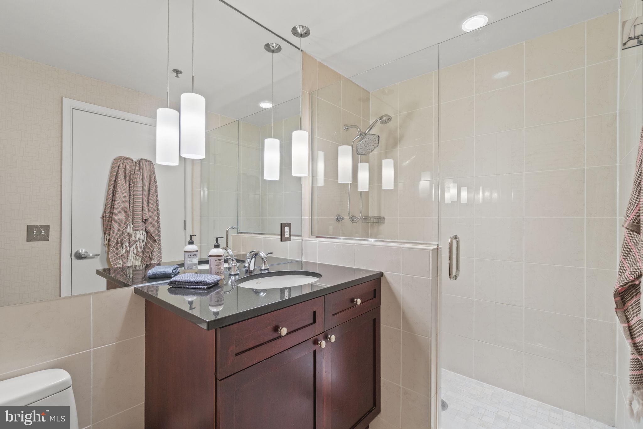 675 E Street Northwest, Unit 500 Washington, DC 20004 - Photo 18 of 52 a bathroom with a double vanity sink and a mirror