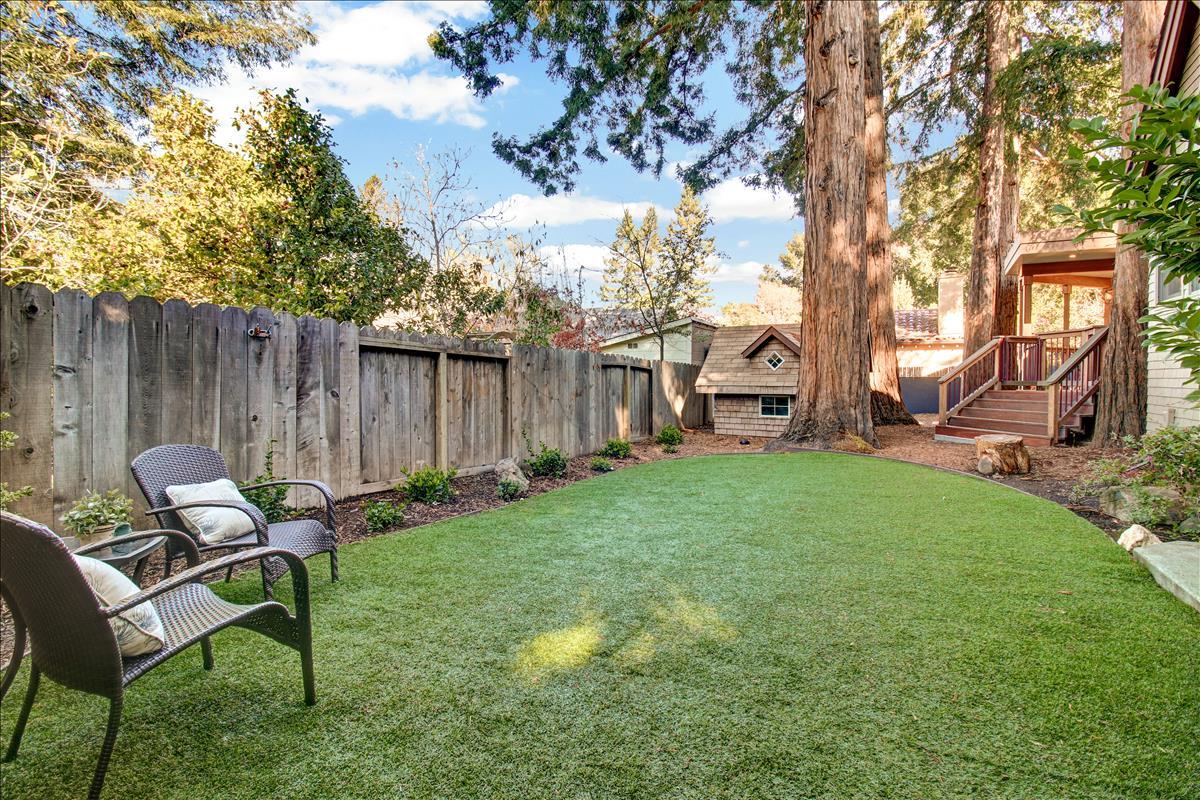 836 Creek Drive Menlo Park, CA 94025 - Photo 35 of 39 a view of a backyard with table and chairs and a fire pit