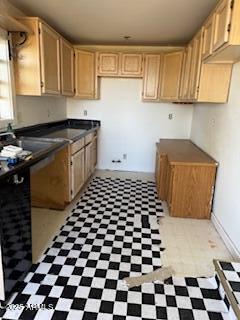 203 3rd Street Jerome, AZ 86331 - Photo 11 of 18 a kitchen with a checkered floor and white cabinets