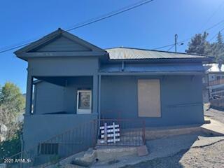 203 3rd Street Jerome, AZ 86331 - Photo 2 of 18 a front view of a house with a yard