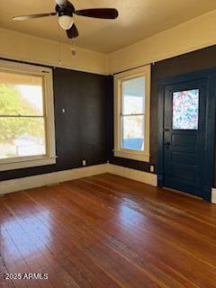 203 3rd Street Jerome, AZ 86331 - Photo 9 of 18 an empty room with wooden floor fan and windows