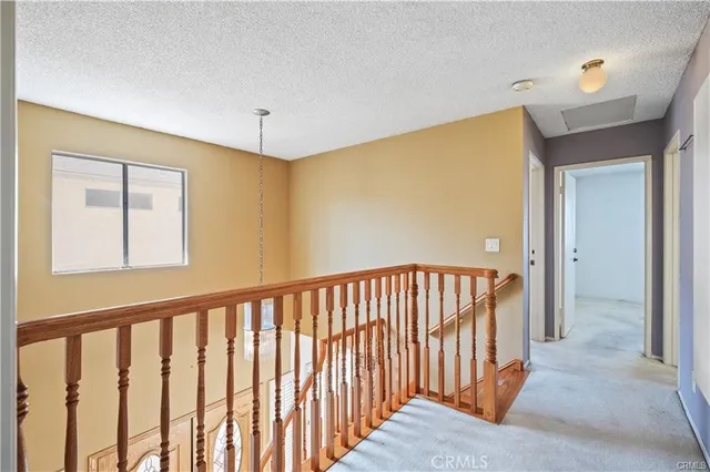 a view of a hallway with a staircase