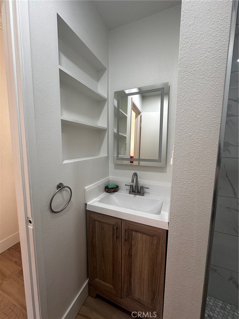 25626 1/2 Oak Street Lomita, CA 90717 - Photo 24 of 39 a bathroom with a toilet sink vanity and mirror