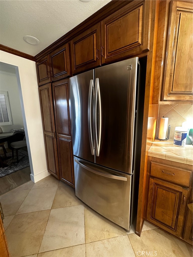 25626 1/2 Oak Street Lomita, CA 90717 - Photo 9 of 39 a view of a refrigerator in kitchen and an empty room