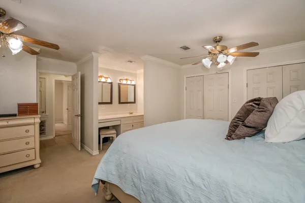 a bedroom with a bed and a chandelier