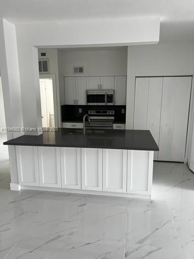 a kitchen with cabinets and a stove top oven