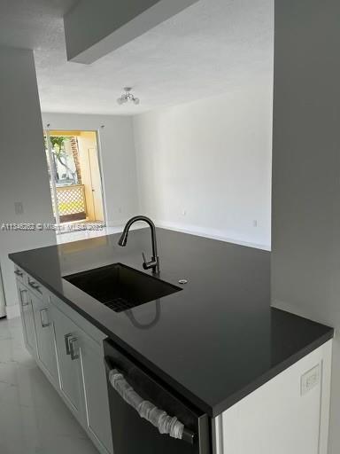 18344 Northwest 68th Avenue, Unit F Hialeah, FL 33015 - Photo 3 of 14 a close view of a sink a counter space and a stove top oven