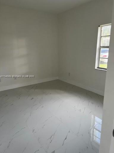 18344 Northwest 68th Avenue, Unit F Hialeah, FL 33015 - Photo 6 of 14 an empty room with a window