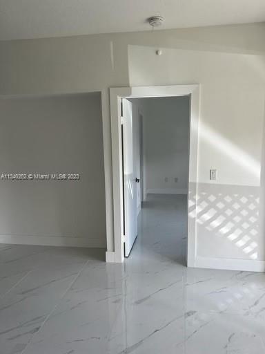 18344 Northwest 68th Avenue, Unit F Hialeah, FL 33015 - Photo 7 of 14 an empty room with cabinet and mirror