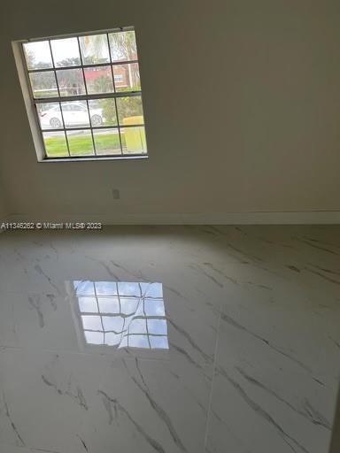 18344 Northwest 68th Avenue, Unit F Hialeah, FL 33015 - Photo 9 of 14 an empty room with windows