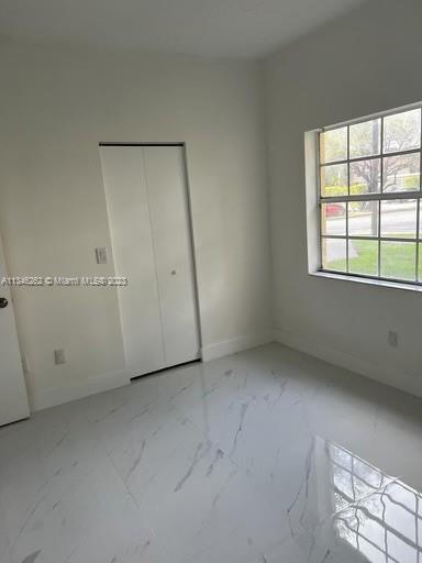 18344 Northwest 68th Avenue, Unit F Hialeah, FL 33015 - Photo 10 of 14 an empty room with a window