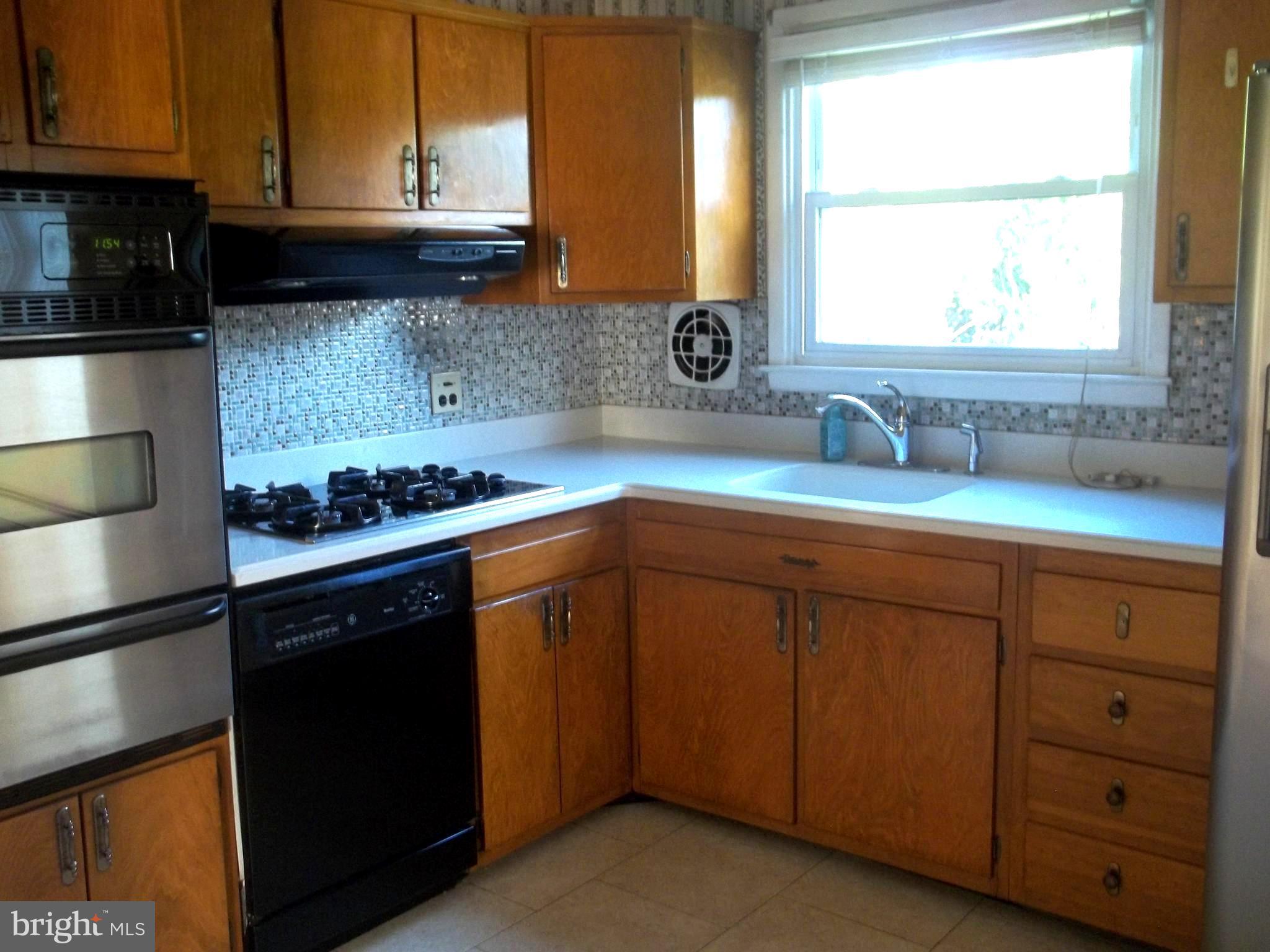 5 Broadale Road Doylestown, PA 18901 - Photo 15 of 27 a kitchen with granite countertop a sink cabinets and window