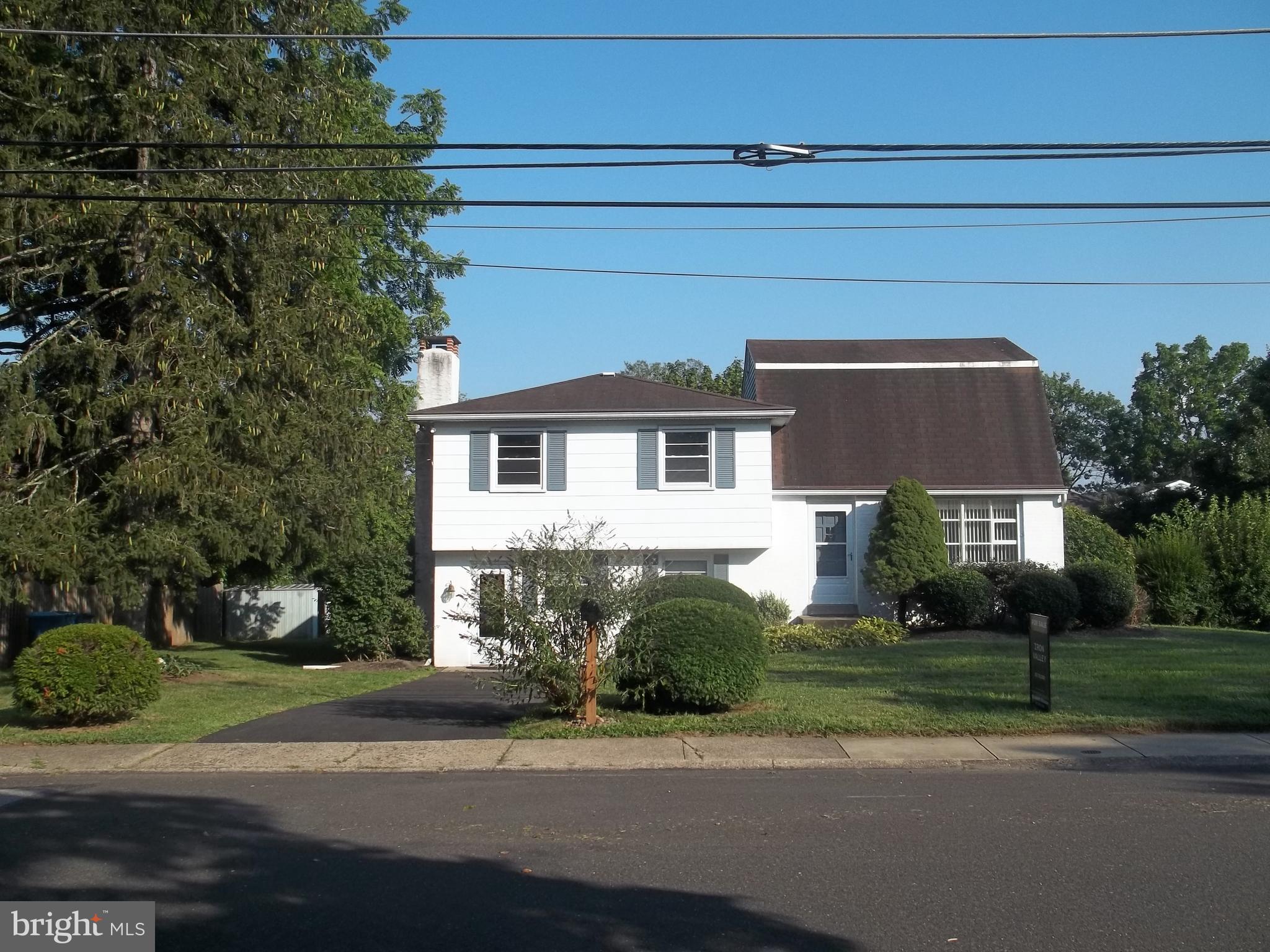 5 Broadale Road Doylestown, PA 18901 - Photo 4 of 27 a front view of a house with a yard and garage