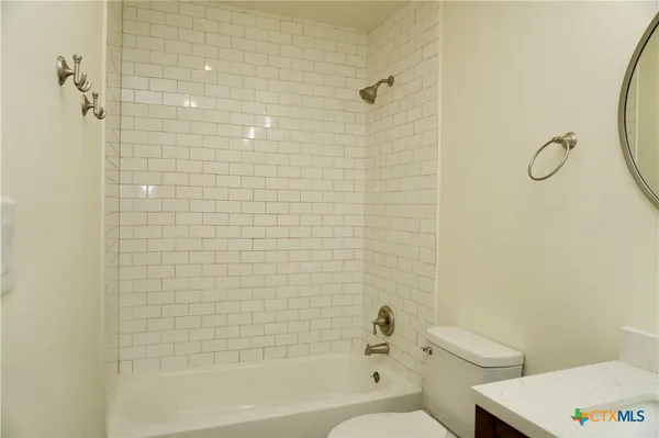 a bathroom with a toilet and a tub