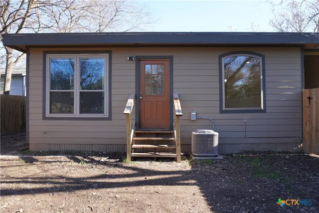 a front view of a house with stairs